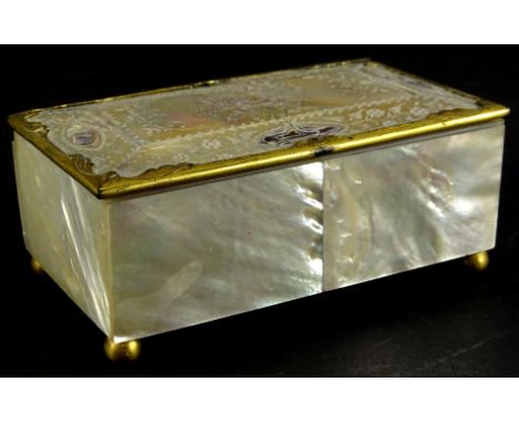 A late 19thC continental mother of pearl jewellery box, with gilt metal mounts, engraved with flowers etc., padded interior o