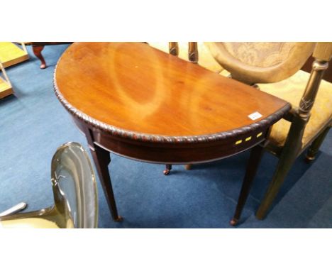 A mahogany half moon fold over card table.  89 cm wide