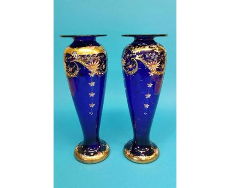 A pair of Victorian blue glass and floral enamel decorated tapering vases. 35cm height