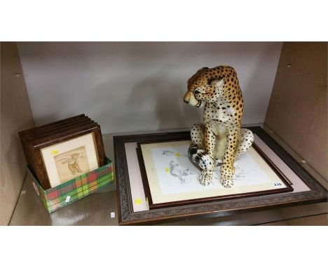Various prints and a ceramic leopard
