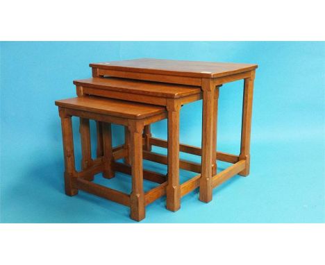 A Robert Mouseman Thompson of Kilburn nest of three oak tables, each leg with a carved mouse. 61 cm wide