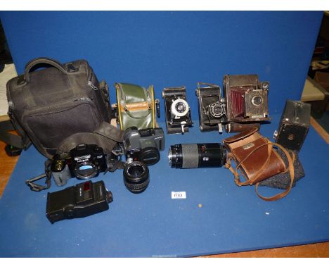 A quantity of cameras to include;  Minolta SLR camera plus lenses, flash and case, Olympus Super zoom camera, folding pocket 