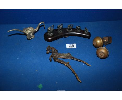 A brass betel nut cutter Chopping tool in the form of horse, two brass clock finials, five opium weights on a curved wooden s