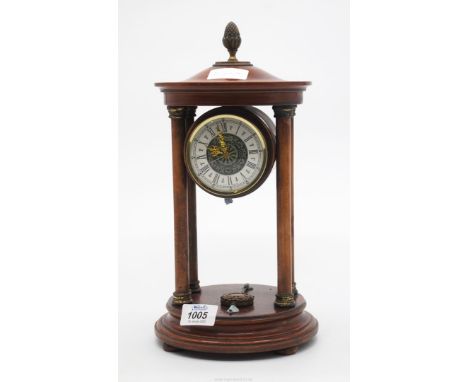 A quartz movement mantel clock, the drum shaped timepiece supported on four turned wood pillars having turned wood upper and 