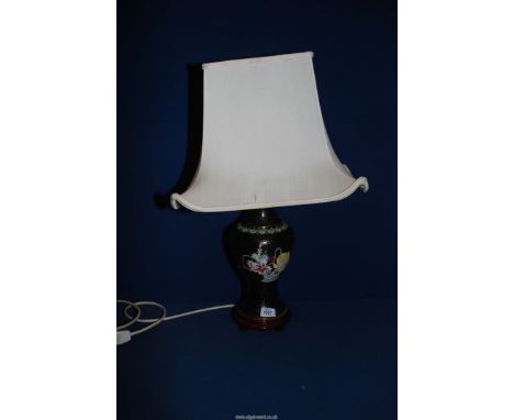 A twin black cloisonne table lamp with cream shade, 26'' tall