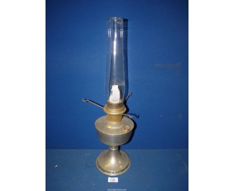An Aladdin metal oil lamp with clear chimney, 23" tall.