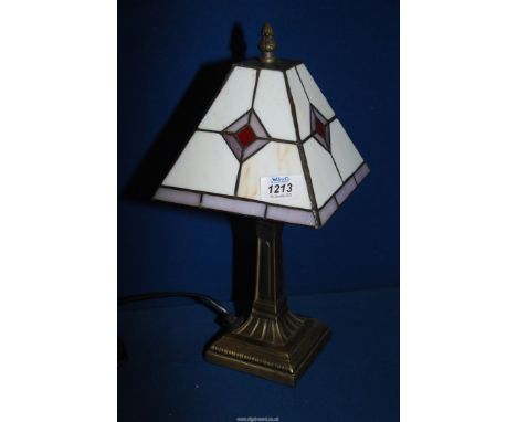 A small Tiffany style table lamp with white ground and purple diamond pattern (one panel cracked), metal base, 14" tall.