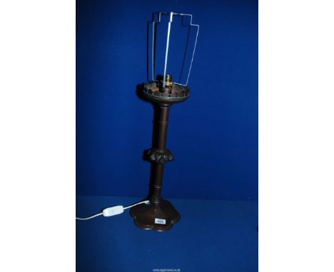 A tall bronze effect Arts and Craft Candle Holder converted to a table lamp with floriate shaped base, 21" tall.