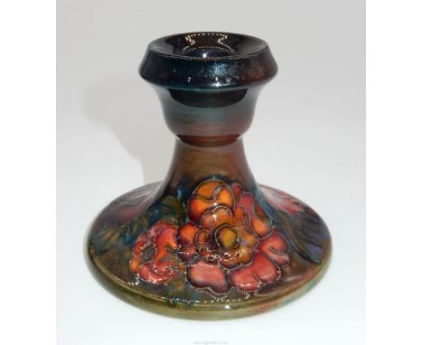 A Moorcroft dumpy Candlestick decorated with anemones, 3 1/2" tall.