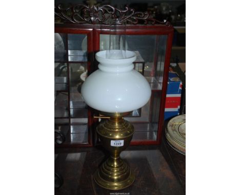 A brass Oil lamp with twin burner and white shade.