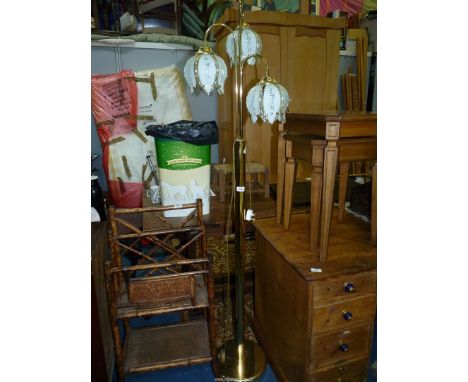 A brass standard lamp having three petal shape shades.