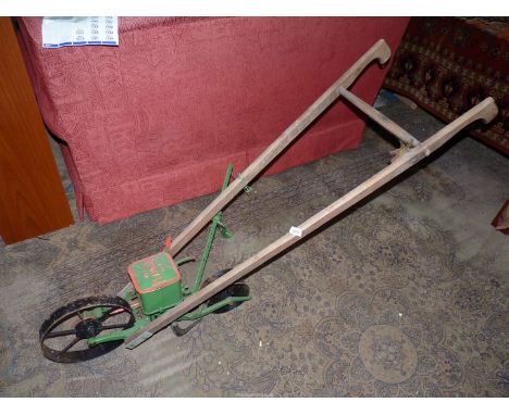 A U.S.A. Planet JR No. 4 pedestrian operated walk-behind Seed Drill with two spare seed feed wheels and complete with an adju