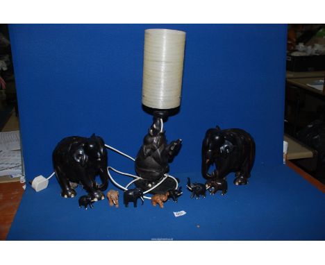 A quantity of Ebony and treen Elephants including large table lamp, large pair of elephants and others, etc.