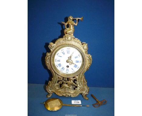 An ornate brass cased Mantel clock of French design, the single train movement having a white enamel face with Cobalt blue Ro