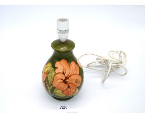 A pretty Moorcroft lamp base with a coral Hibiscus pattern. 11 " tall