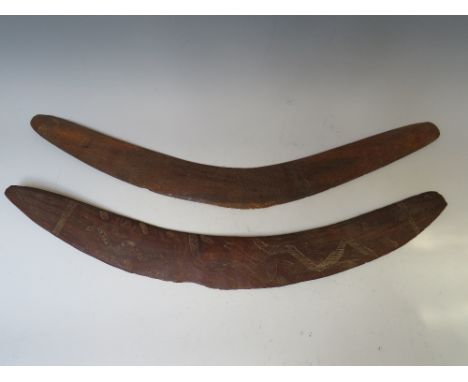 TWO OCEANIC AUSTRALIAN ABORIGINAL EARLY 20TH CENTURY HUNTING BOOMERANGS, with carved designs, longest W 63 cm (2)
