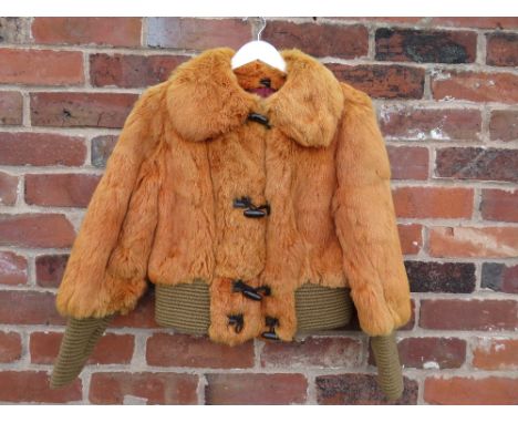 A VINTAGE 1970s BURNT ORANGE CONEY FUR JACKET, with typical shaped collar, elasticated waist and elongated cuffs, toggle fast
