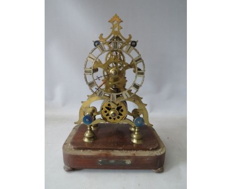 A SINGLE FUSEE SKELETON CLOCK WITH GLASS DOME, having a Gothic waisted frame, pierced decorative spring barrel, five spoke co