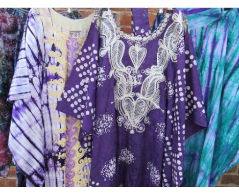 A COLLECTION OF FOUR PURPLE TONE MID CENTURY&nbsp;&amp; LATER&nbsp; AFRICAN AGBADA KAFTAN ROBES, comprising a sateen tie dyed