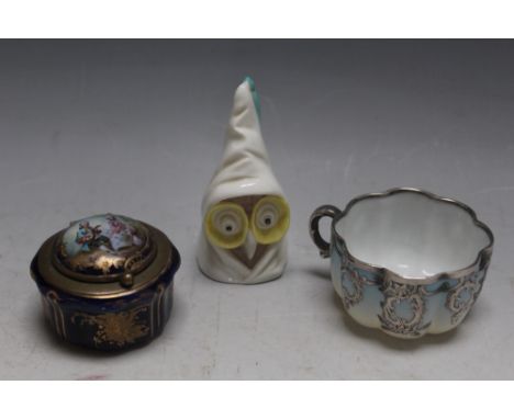 A BRASS MOUNTED PORCELAIN SNUFF BOX, together with a Royal Worcester 'owl' candle snuffer and a silver overlay mini teacup, W
