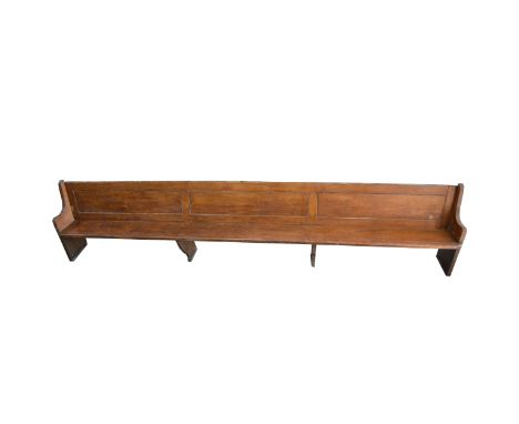 Oak bench, three rectangular panels to the back, boarded seat, standard ends, length 454cm, depth 45cm, height 95cm. Removed 