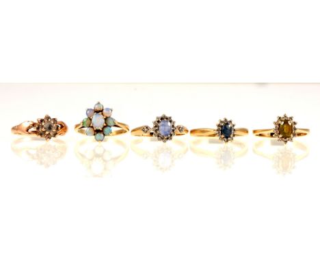 A sapphire and diamond cluster ring, the oval mixed cut sapphire claw set, surrounded by twelve small round brilliant cut dia