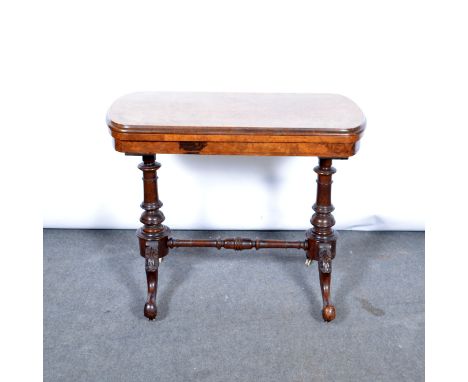 Victorian walnut card table, oval foldover top enclosing a baize playing surface, turned supports and rail, carved cabriole l