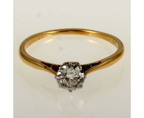A diamond solitaire ring, the old brilliant cut stone claw set in a yellow and white metal mount, shank marked 18ct Plat, rin