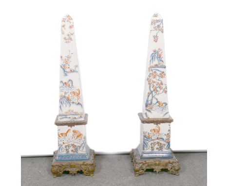 Pair of reproduction gilt metal mounted stoneware floor-standing obelisks, of 18th Century design, 76cm; and a modern blue an