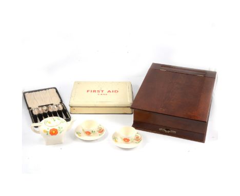 A reproduction mahogany writing slope, with a drawer under, width 28cm; "First Aid Case" and 1937 George VI Coronation embroi