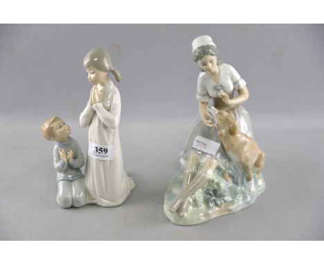 One Lladro and one NAO figural group, including a woman seated with a dog,