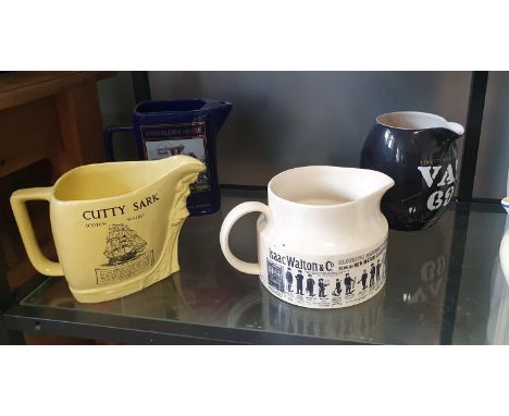A collection of 14 vintage water jugs featuring a range of popular whisky brands