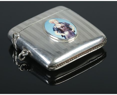 A George V silver and enamel vesta case with engine turned decoration. Assayed Chester 1911 by Walker &amp; Hall.  Some denti