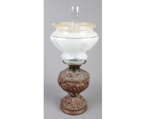 A ornate metal and glass oil lamp.  