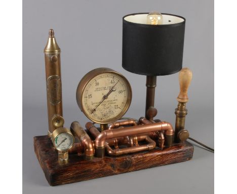 A Steampunk style table lamp with gauges and pipes.  Working.