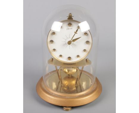 A West German Kaiser torsion clock under glass dome with globe pendulum.  