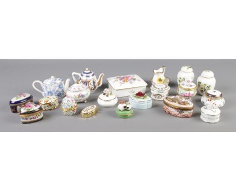 A large collection of mainly ceramic trinket boxes, to include large Royal Crown Derby example, along with several Leonardo C