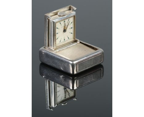 A vintage silver travelling timepiece by Dunhill. With engine turned decoration to case. Stamped 925.  Running.
