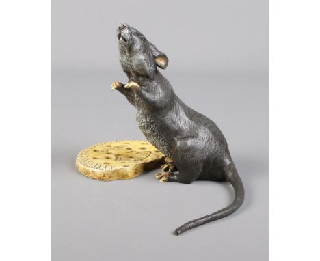 A cold painted bronze model of a rat with a Cao Biscuit. Bearing Franz Bergman stamp.  