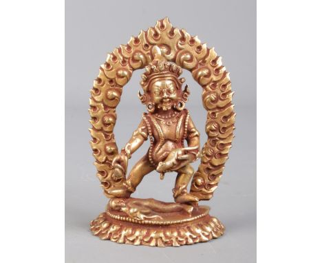 A small bronze devotional figure formed as Jambhala. 8.5cm.  