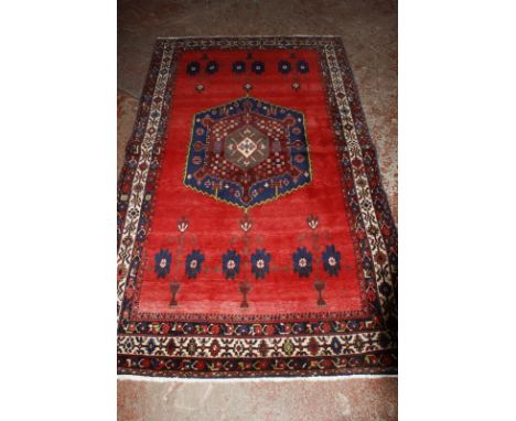 A red Afshar carpet 277 x 164cm