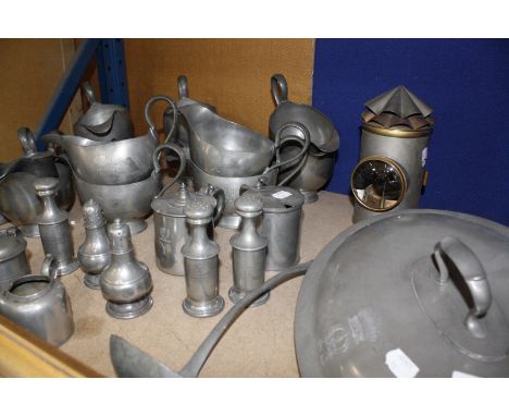 A quantity of pewter items to include condiments, gravy boats, tankards, tureen covers etc and a lamp