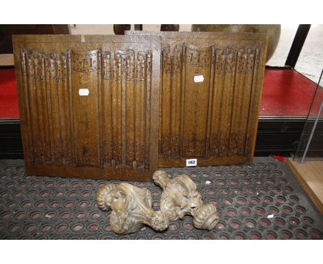 An oak ogee carved arch, two light wood finials and two oak panels with relief carving