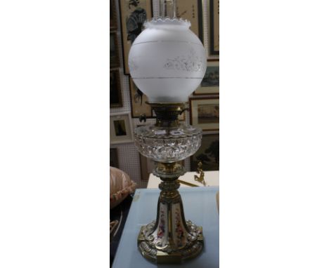 A glass oil lamp, with brass and ceramic shaped base, 65cm high approx.