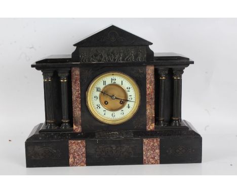 Victorian black slate mantle clock, the white dial with Arabic numerals, with a arched pediment above a scene of horses with 
