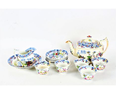 19th century porcelain part tea service, decorated in the Chinese manner, comprising tea pot, two plates, milk jug, five tea 