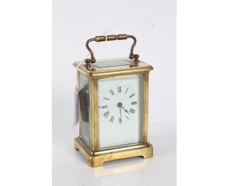 French brass cased carriage clock, the white enamel dial with black roman numerals, visible platform escapement, with key, 11
