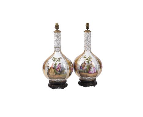 A PAIR OF LARGE DRESDEN BOTTLE VASESCIRCA 1900Typically decorated with flowers and Watteauesque panels, on carved Chinese sty