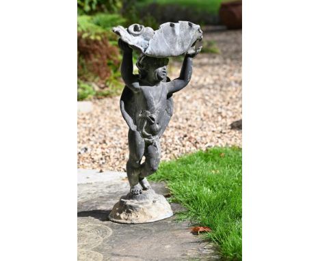 A LEAD FIGURAL BIRD BATH20TH CENTURYIn the manner of H. Crowther, modelled with a standing putto raising a scallop shell basi