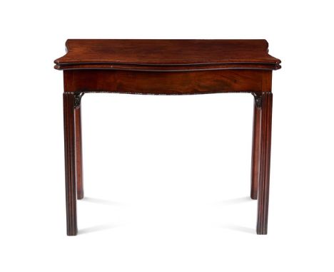 A GEORGE III MAHOGANY CARD TABLECIRCA 1780, IN THE MANNER OF THOMAS CHIPPENDALE Of serpentine outline, with moulded baize lin